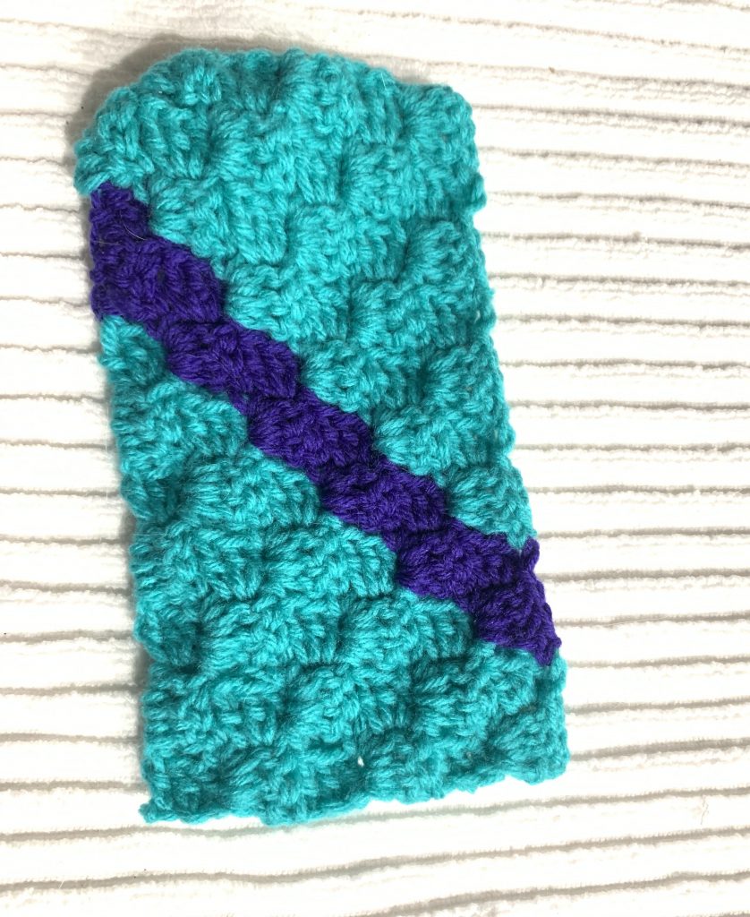 c2c crocheted rectangle with a stripe